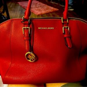 MK red bag Has a few minor scratches in the back that can probably be cleaned